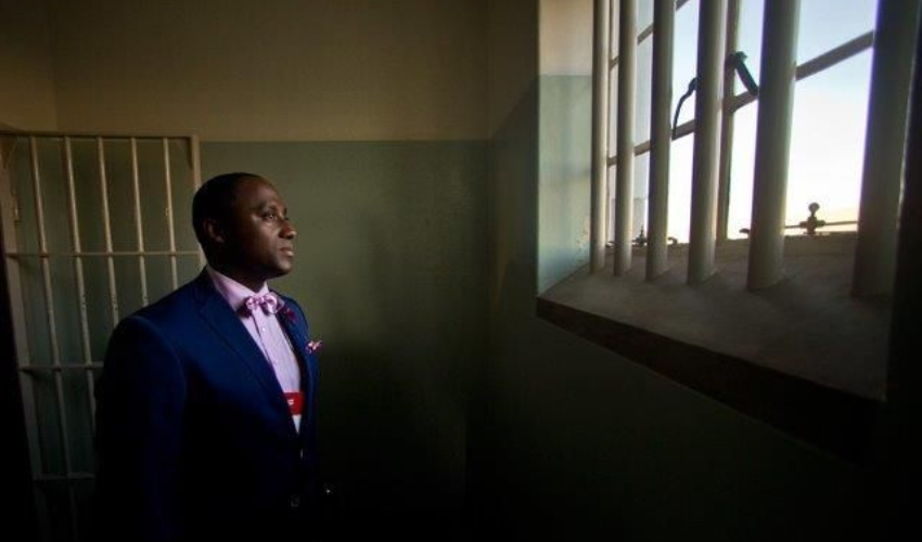 Sherwin in Nelson Mandela's Cell at Robben Island